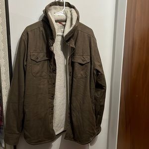 An olive green button up wool-lined men’s jacket